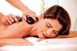 Eine Frau genießt eine Massage im Spa der Johannesbad Therme Bad Füssing.
