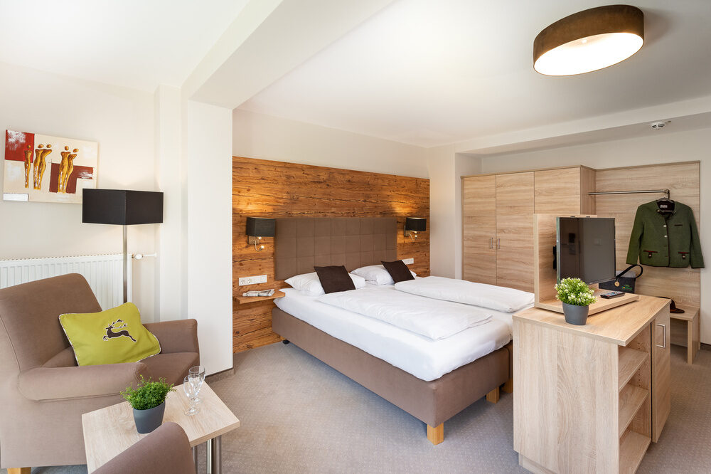 Der elegante Schlafbereich im Doppelzimmer-Premium-Plus im Richstein's Posthotel Bad Füssing bringt Komfort.